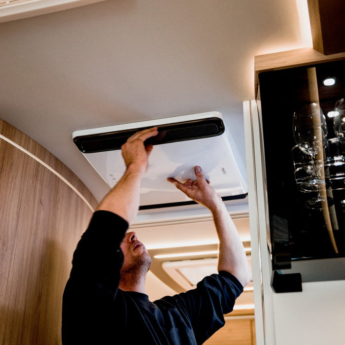 Mestic rooftop AC interior panel showing controls and flush ceiling installation