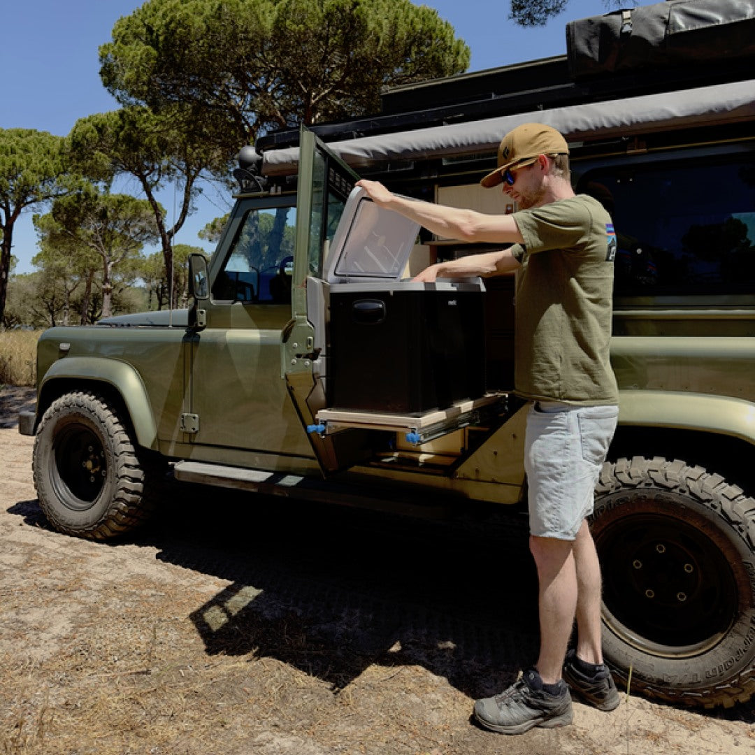 Mestic cool box used as a portable fridge inside a custom-built camping vehicle