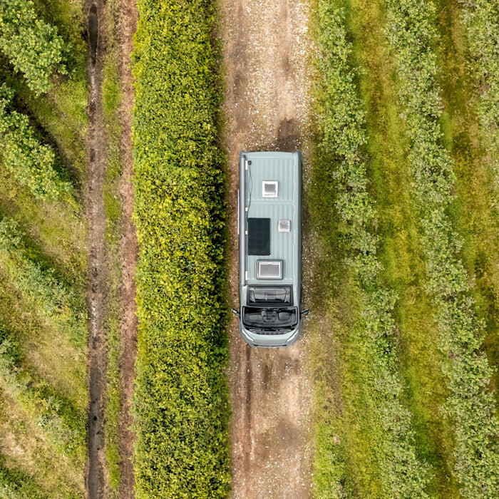 Aerial view of a van conversion with a Mestic solar panel mounted on the roof