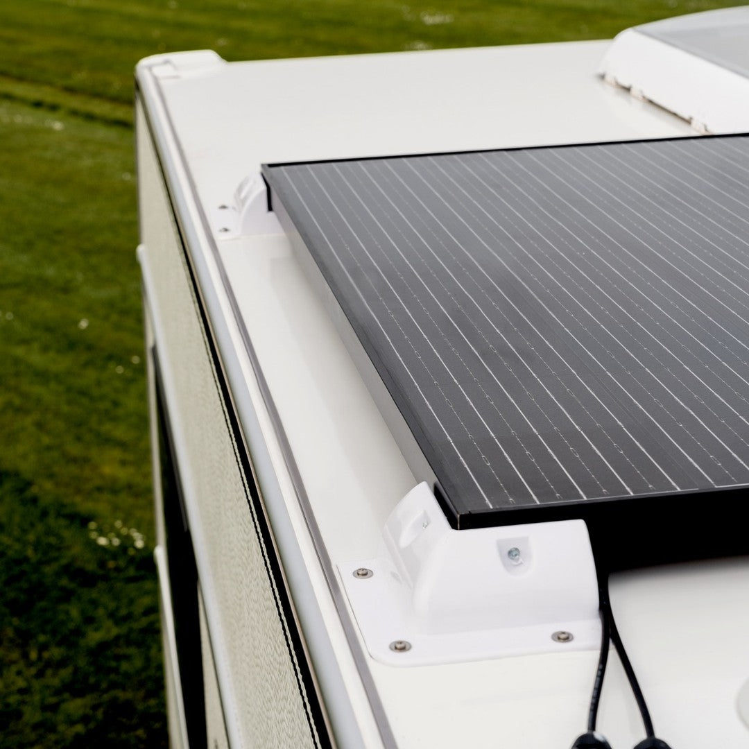 Detailed view of a solar panel installed on a caravan roof for sustainable camping power