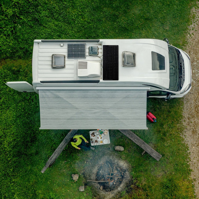 Aerial view of a motorhome with white Mestic rooftop air conditioner and awning deployed