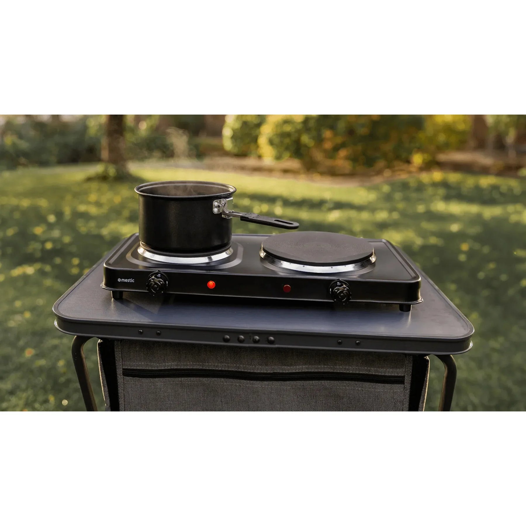Mestic double electric stove cooking a meal outdoors — ideal for campsite hookup cooking