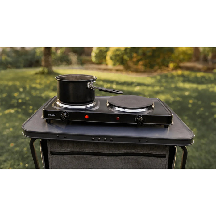 Mestic double electric stove cooking a meal outdoors — ideal for campsite hookup cooking