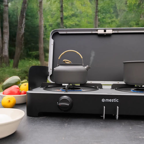 Mestic portable gas hob with kettle and camping cookware outdoors, ideal for motorhome and caravan cooking