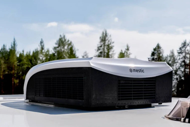 Mastic roof top air conditioner on a vehicle with trees in the background